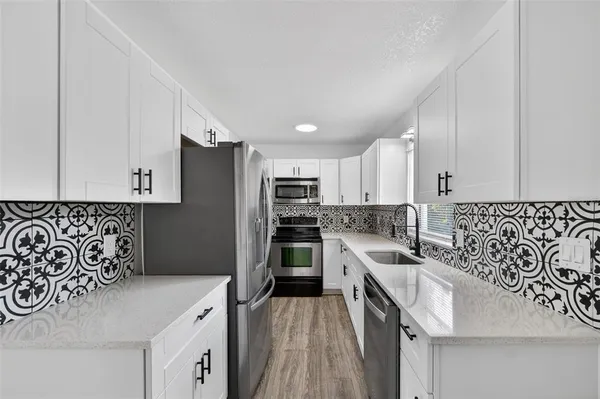 a bedroom with a large bed and a flat screen tv