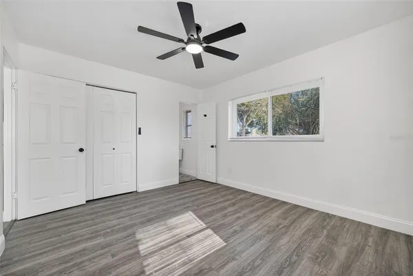 a front view of a house with a yard and potted plants