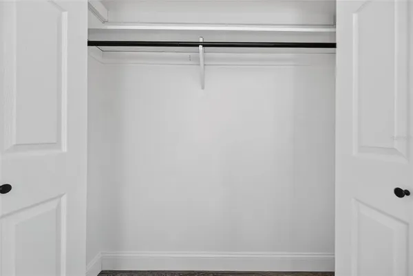 an aerial view of residential houses with outdoor space and parking