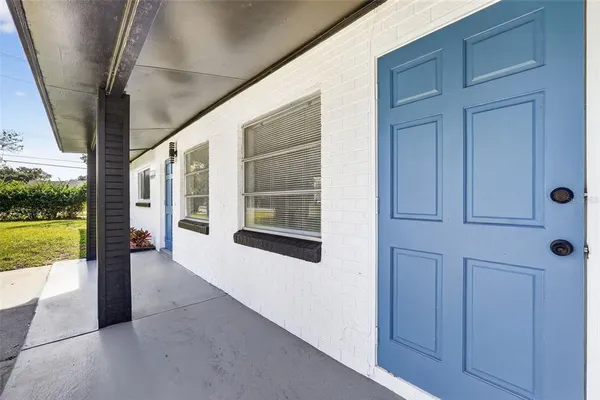 a view of a room with wooden floor and ceiling fan
