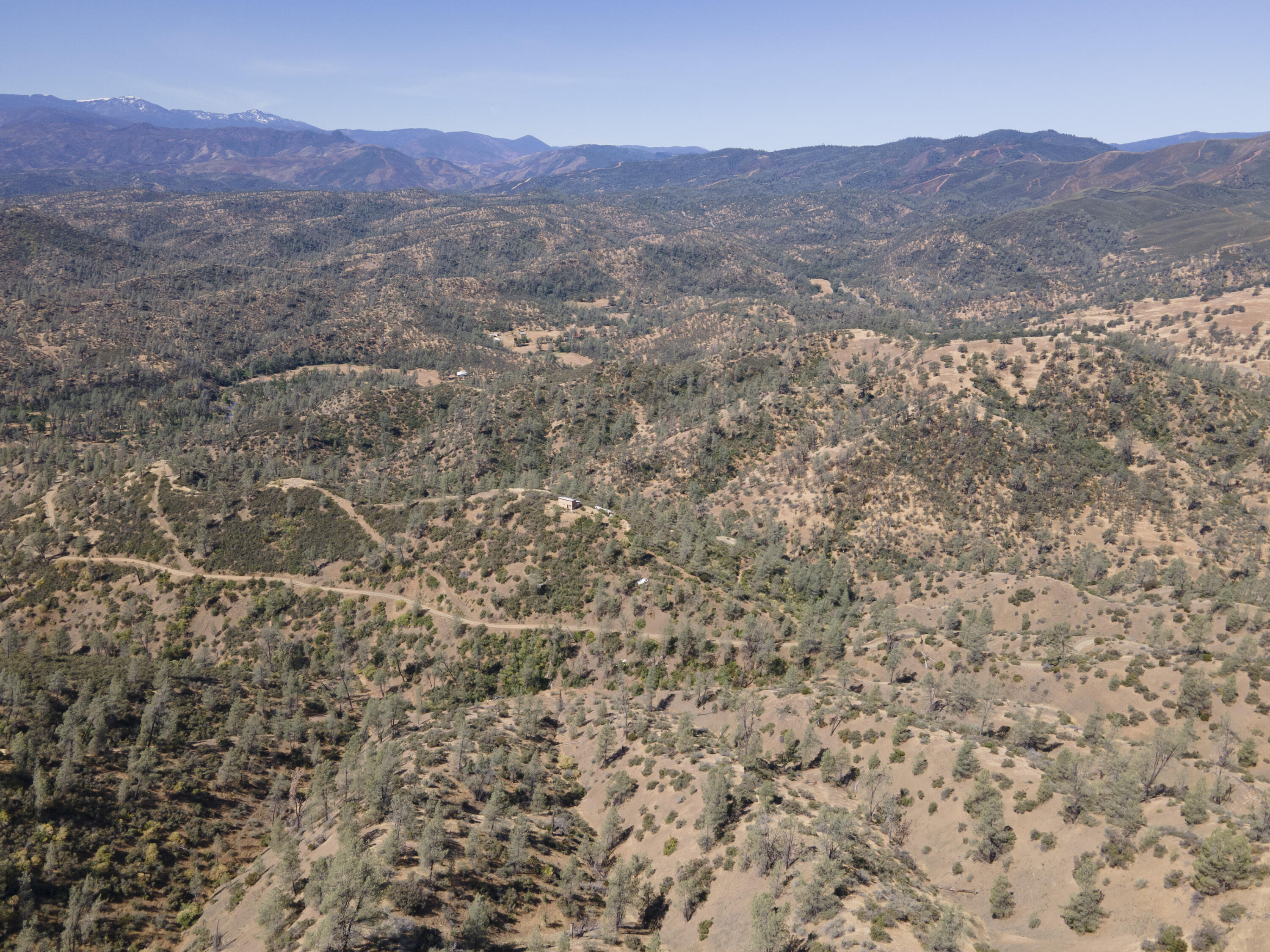 4100 Yolla Bolly Road Igo, CA 96047 - Photo 7 of 24 a view of a dry yard with mountains in the background