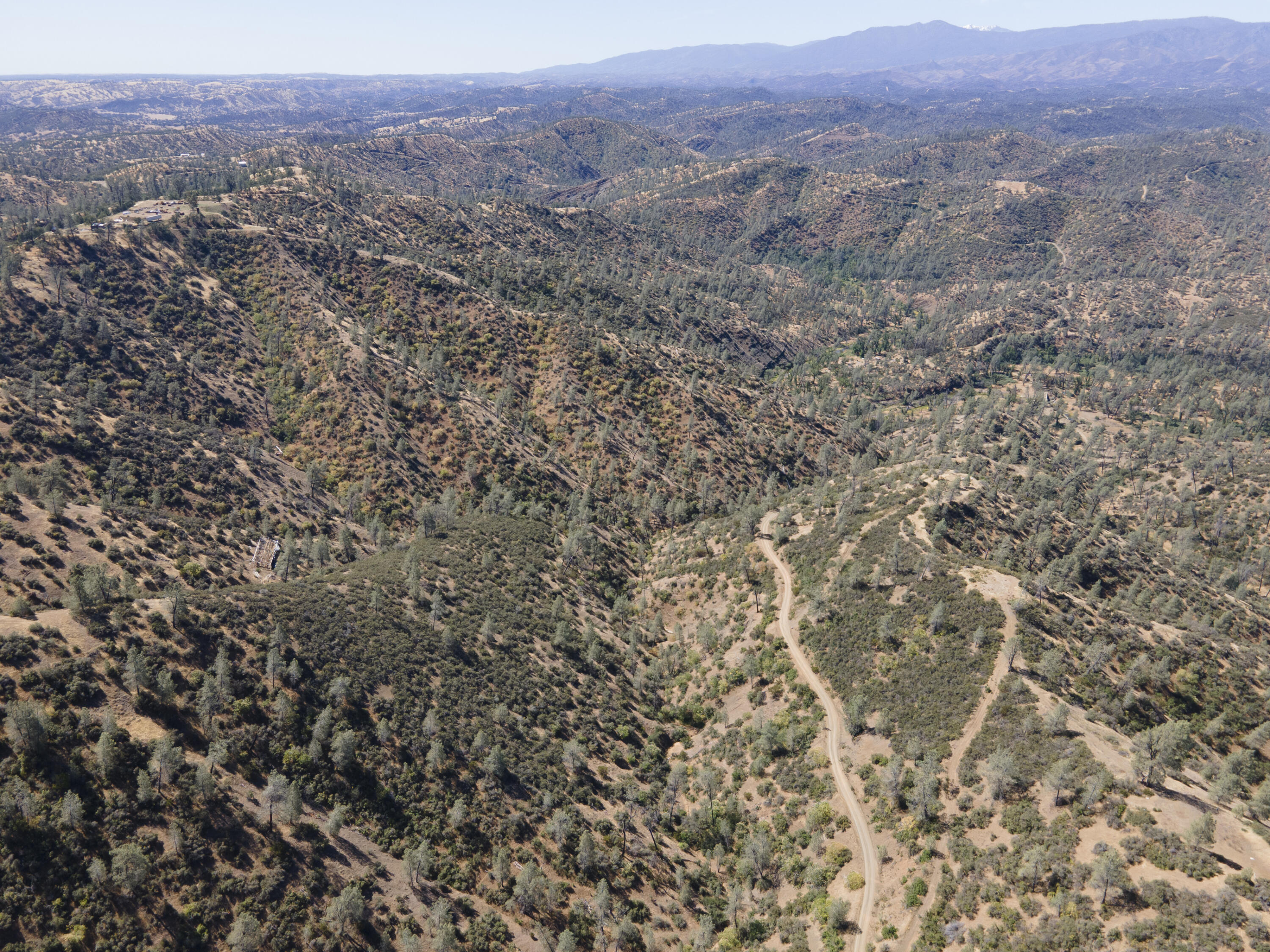4100 Yolla Bolly Road Igo, CA 96047 - Photo 9 of 24 a view of a dry yard with mountains in the background