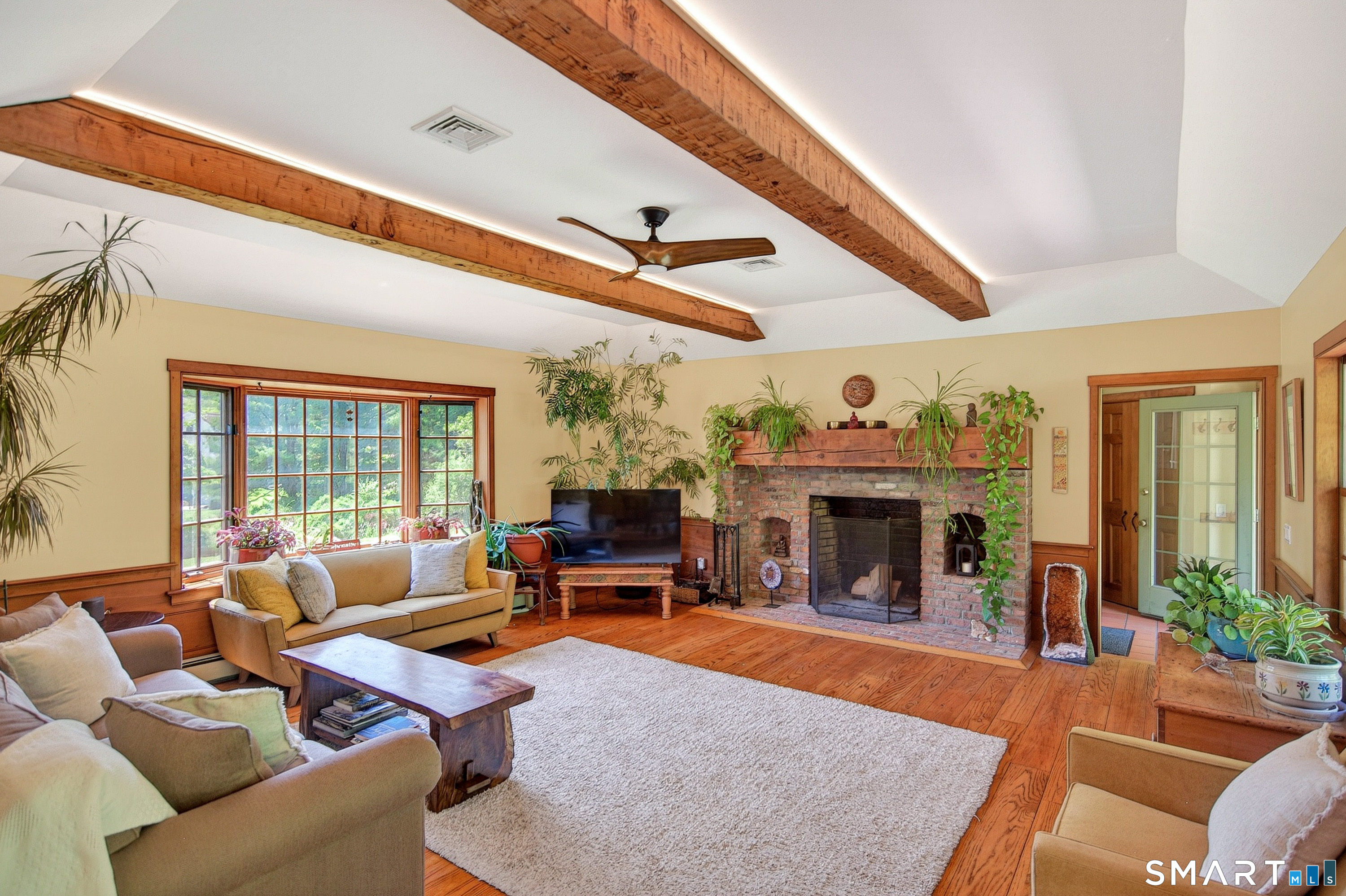 174 Huntingtown Road Newtown, CT 06470 - Photo 13 of 40 a living room with furniture a fireplace and a large window