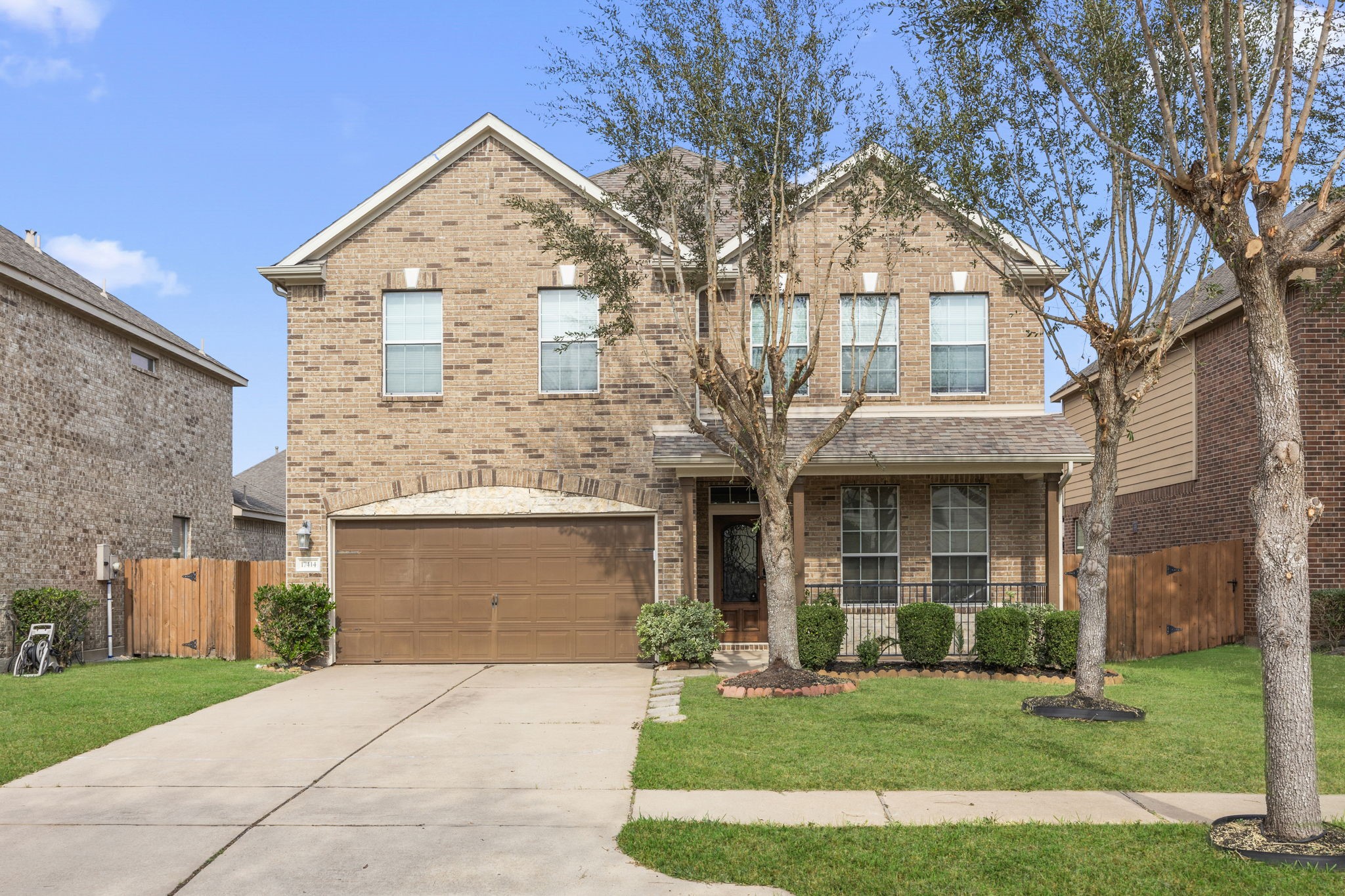 a front view of a house with a garden and yard