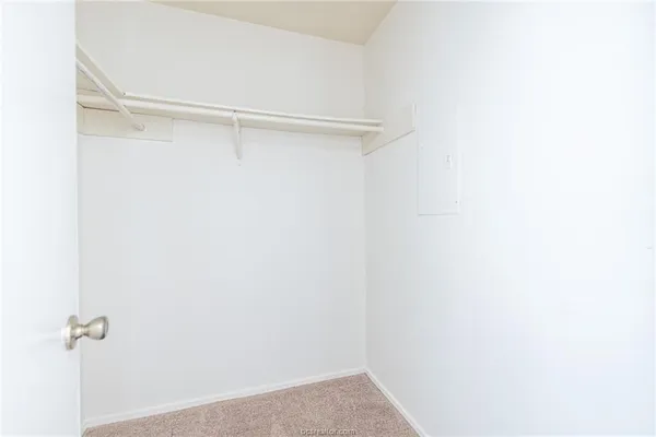 a bathroom with a granite countertop sink a toilet and a mirror