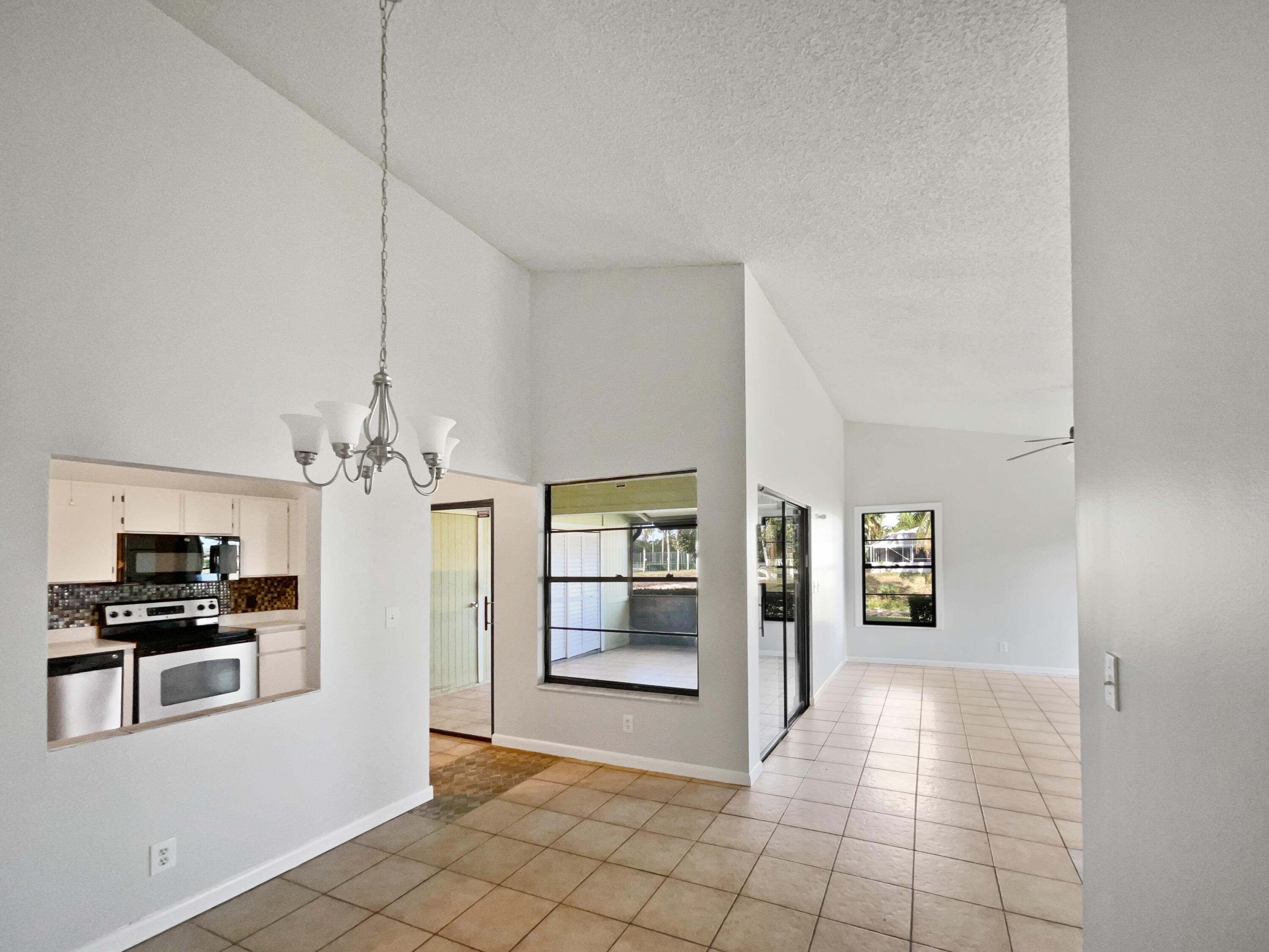 4249 Willow Pond Circle West Palm Beach, FL 33417 - Photo 15 of 30 a view of a kitchen with an empty room and fire place