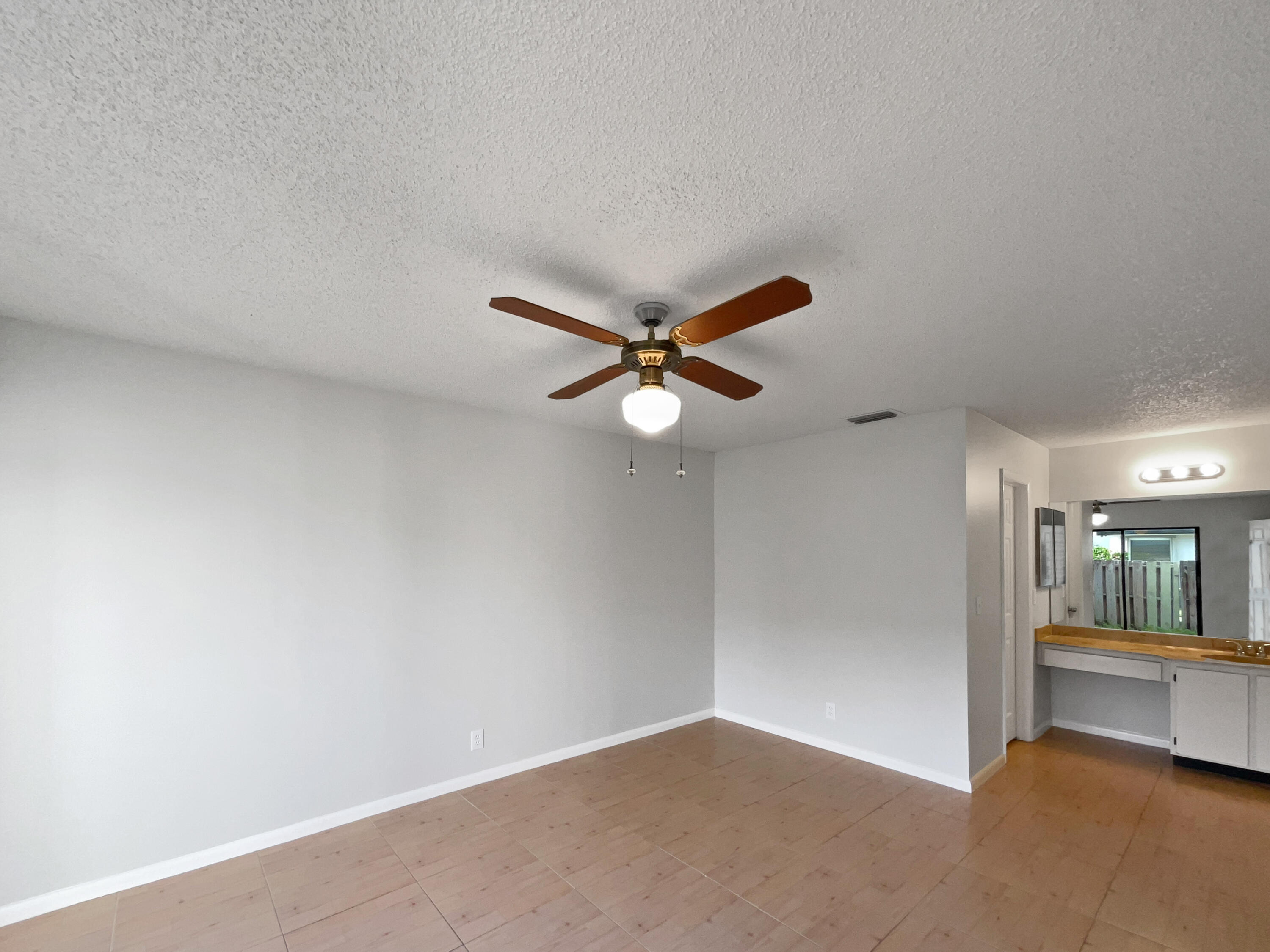 4249 Willow Pond Circle West Palm Beach, FL 33417 - Photo 5 of 30 an empty room with fan and windows