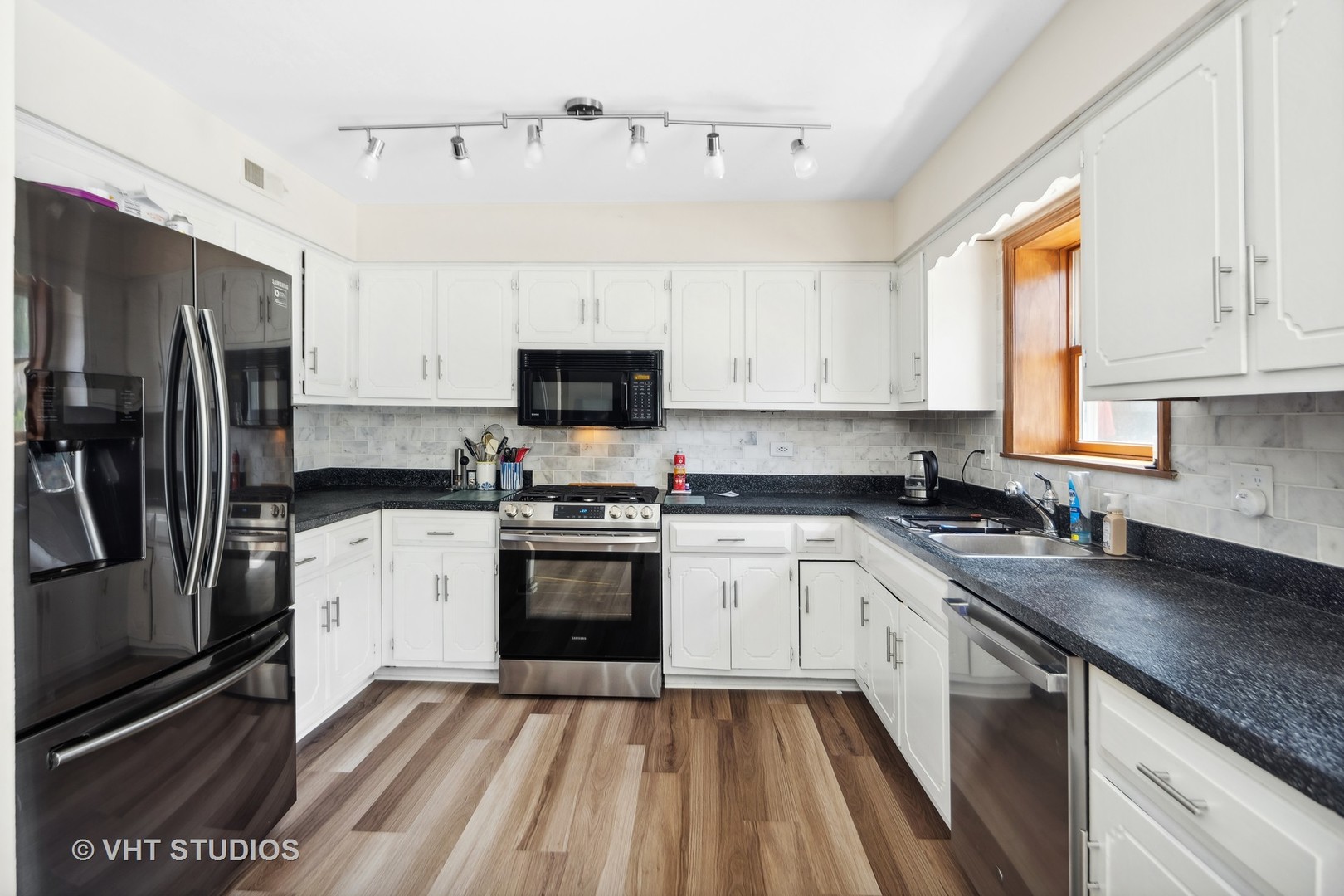 718 Raintree Drive Naperville, IL 60540 - Photo 16 of 41 a kitchen with stainless steel appliances granite countertop a sink a stove a refrigerator cabinets and a window