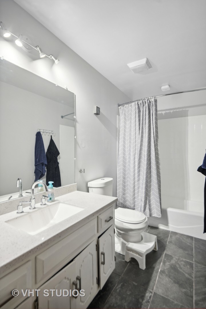 718 Raintree Drive Naperville, IL 60540 - Photo 28 of 41 a bathroom with a double vanity sink toilet and shower