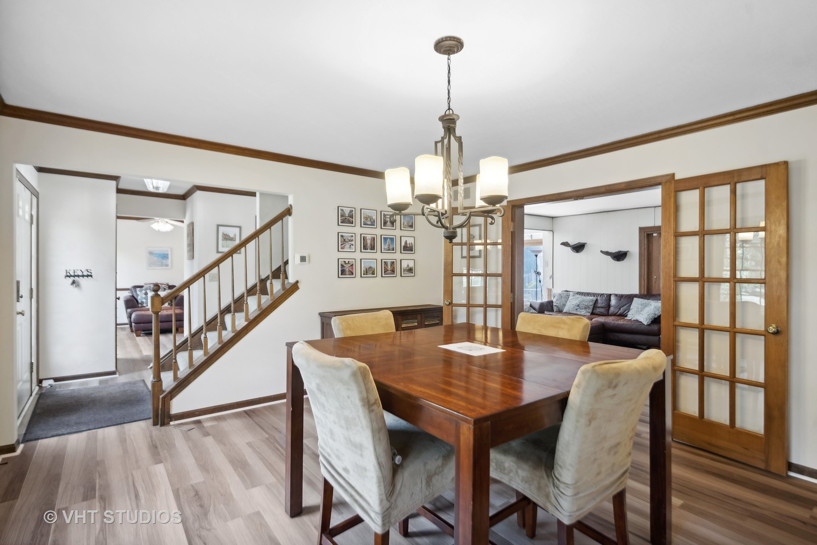 718 Raintree Drive Naperville, IL 60540 - Photo 9 of 41 a view of a dining room and livingroom with furniture wooden floor a chandelier