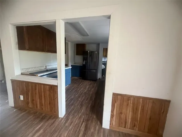 a kitchen with a refrigerator sink and wooden cabinets