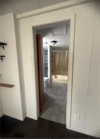 a spacious bathroom with a tub sink and mirror