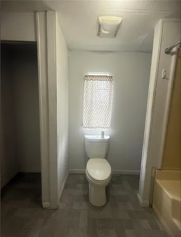 a bathroom with a toilet and a shower