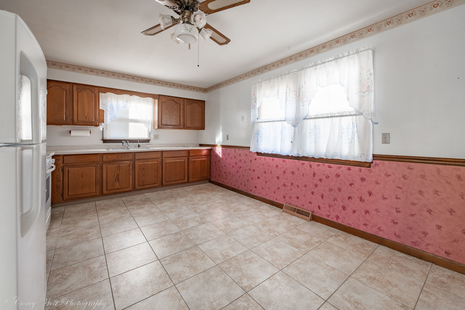 219 Reid Road Genoa, IL 60135 - Photo 7 of 23 a large kitchen with granite countertop a sink window and cabinets