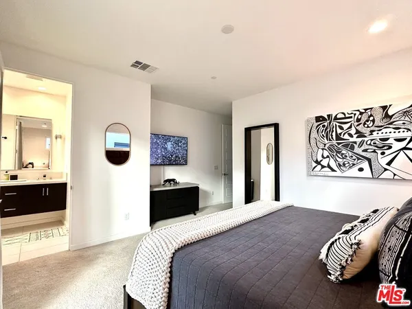 a bedroom with a bed and a couch