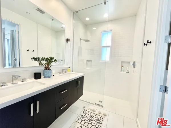 a bathroom with a double vanity sink mirror and