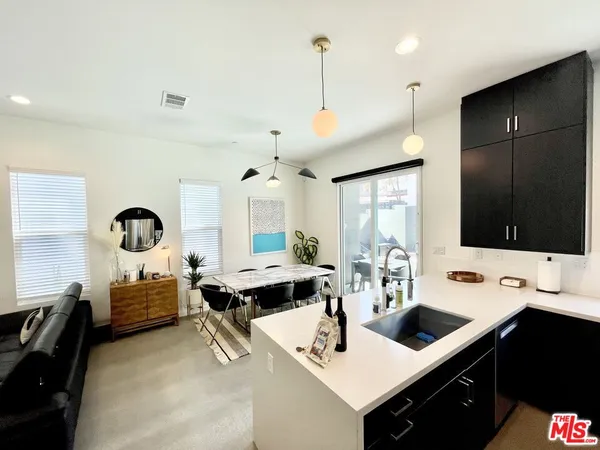 a kitchen with a sink appliances and cabinets