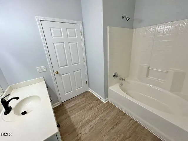 a bathroom with a tub a sink and a shower