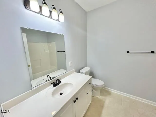 a bathroom with a sink mirror and toilet