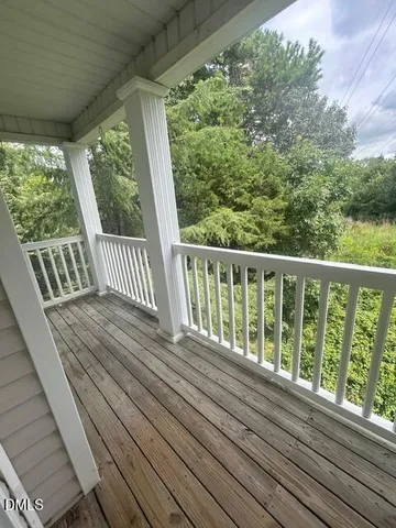 a view of balcony with wooden floor
