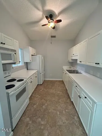 a kitchen with stainless steel appliances a sink stove and cabinets