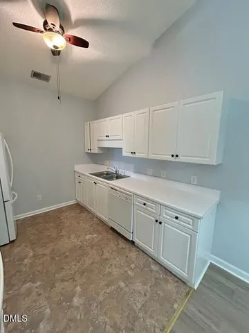 a kitchen with cabinets a sink and appliances