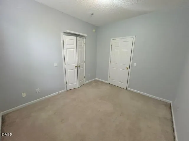 an empty room with closet area
