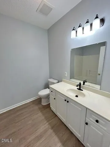 a bathroom with a double vanity sink and mirror