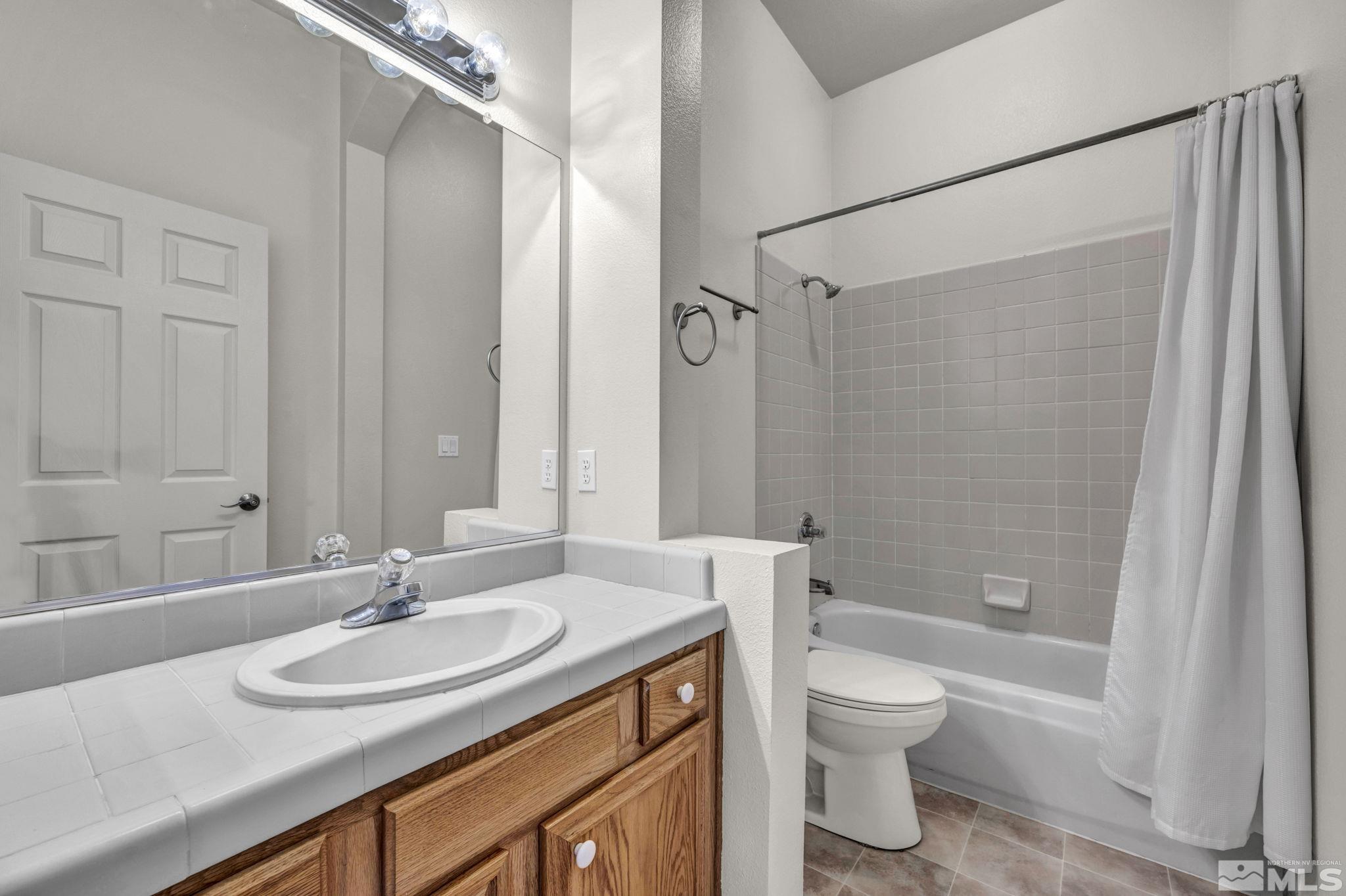 9705 Rolling Rock Court Reno, NV 89521 - Photo 18 of 19 a bathroom with a sink toilet and shower