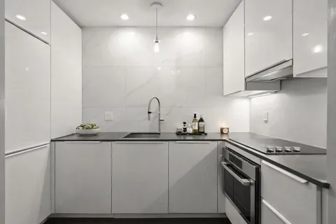 a kitchen with stainless steel appliances granite countertop a sink and cabinets