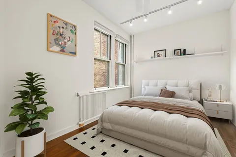 a bedroom with a bed and a window