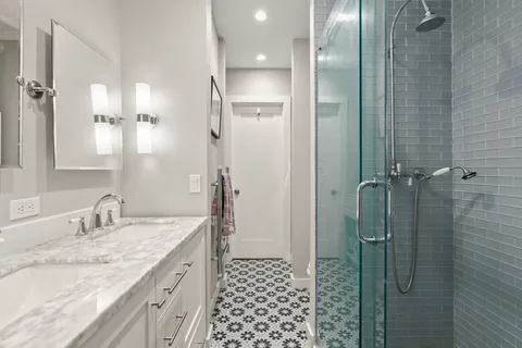 a bathroom with a granite countertop sink a shower and a mirror