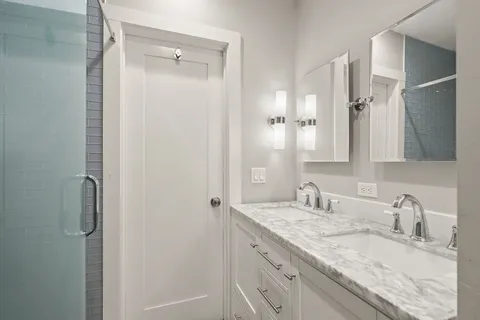 a bathroom with a granite countertop sink mirror and double