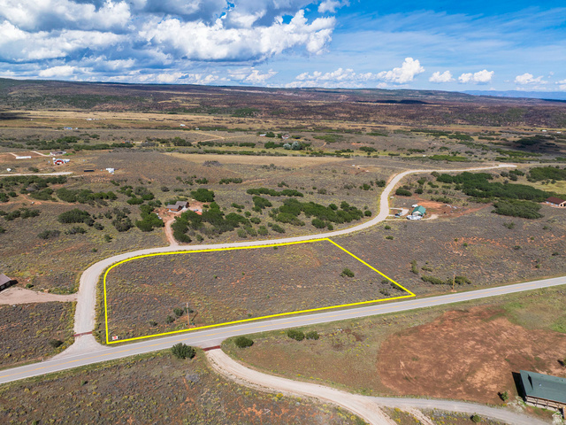 14 East Spring Draw Drive, Unit 13 La Sal, UT 84530 - Photo 10 of 17 Expansive undeveloped lot featuring a paved road frontage, natural vegetation, and a wide-open landscape