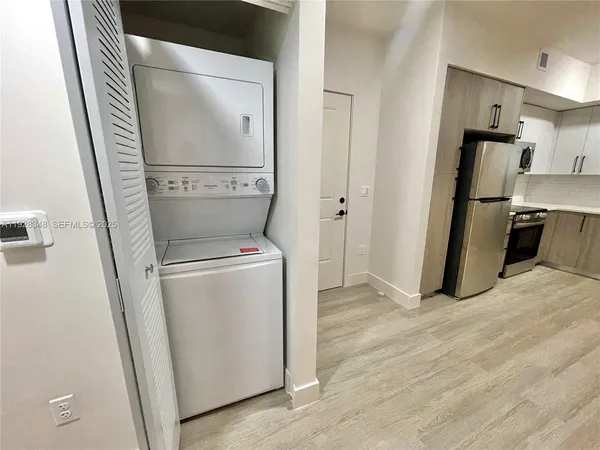 a view of a storage and utility room with washer and dryer