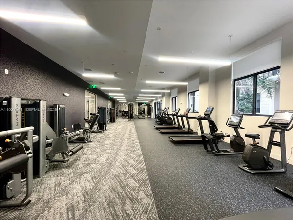 a view of a living room and kitchen with furniture