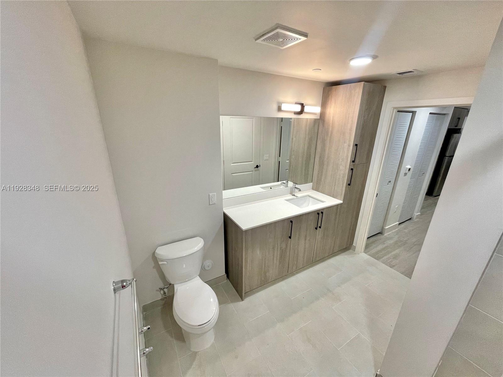18412 Homestead Avenue, Unit 124 Miami, FL 33157 - Photo 9 of 20 a bathroom with a sink toilet and shower