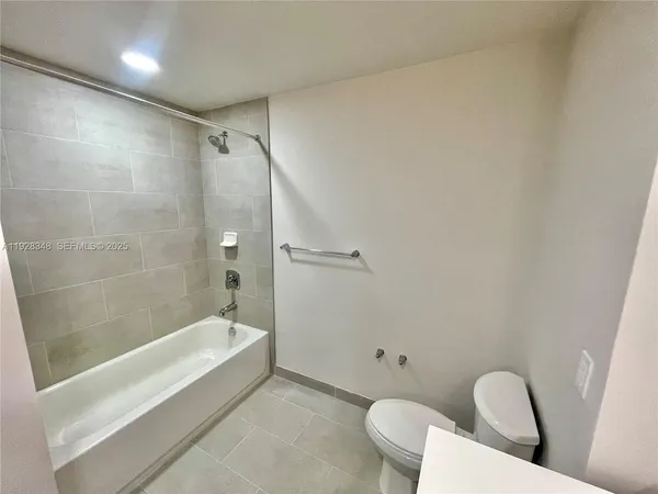 a bathroom with a bathtub and shower