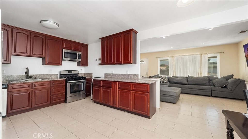 4440 Daniel Drive Riverside, CA 92503 - Photo 11 of 20 a kitchen with stainless steel appliances granite countertop a stove sink and cabinets