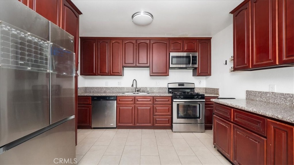 4440 Daniel Drive Riverside, CA 92503 - Photo 10 of 20 a kitchen with stainless steel appliances granite countertop a stove sink and cabinets