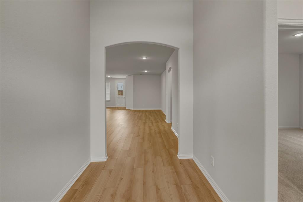 1325 Frio Drive Springtown, TX 76082 - Photo 5 of 24 Entryway featuring wood-finish flooring, an arched doorway, recessed lighting, white baseboards, and light gray wall paint