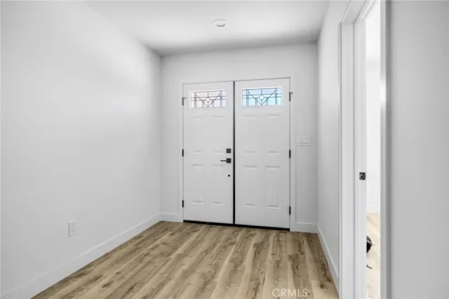 a view of empty room with wooden floor