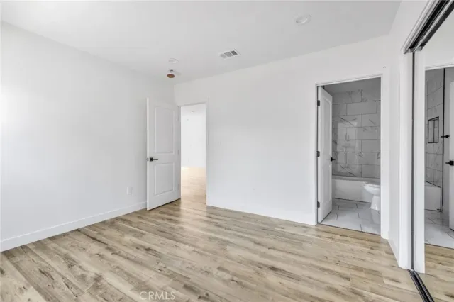 a view of a kitchen with wooden floor and a sink
