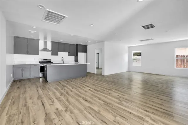 a view of kitchen with furniture and wooden floor