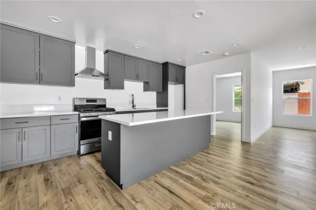 a kitchen with stainless steel appliances a refrigerator and a stove top oven