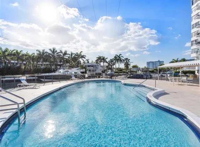 a view of swimming pool with outdoor seating and plants