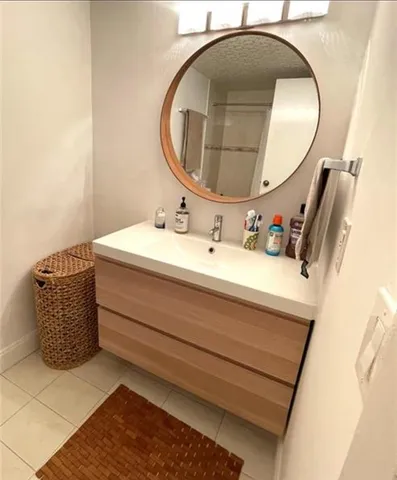 a bathroom with a sink mirror and vanity