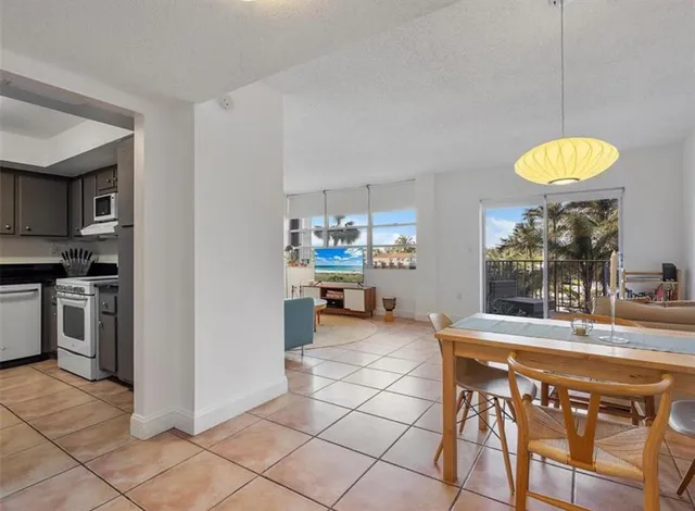 a kitchen with stainless steel appliances granite countertop a stove a sink a microwave and a refrigerator