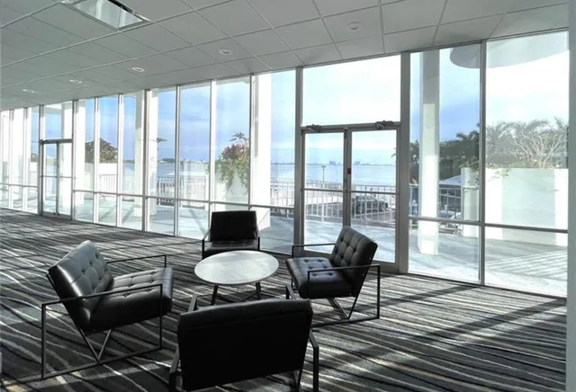 a living room with furniture and a floor to ceiling window