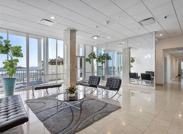 a living room with furniture and a floor to ceiling window